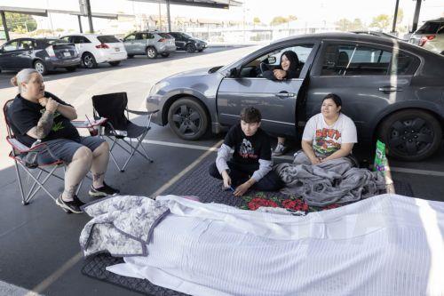epa12989303 Family members from Anaheim, Andrea Luna, Jules Olivas, Joshua Olivas, and Jessica Castro and their 8 cats are sheltering in their cars at JFK High School evacuation center after evacuating their home due to a chemical leak from a large storage tank at the GKN Aerospace facility; in Garden Grove, California USA, 23 May 2026. A failing...