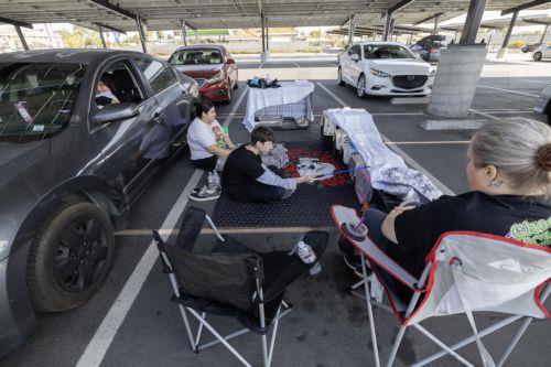 epa12989305 Family members from Anaheim, Andrea Luna, Jules Olivas, Joshua Olivas, and Jessica Castro and their 8 cats are sheltering in their cars at JFK High School evacuation center after evacuating their home due to a chemical leak from a large storage tank at the GKN Aerospace facility; in Garden Grove, California USA, 23 May 2026. A failing...