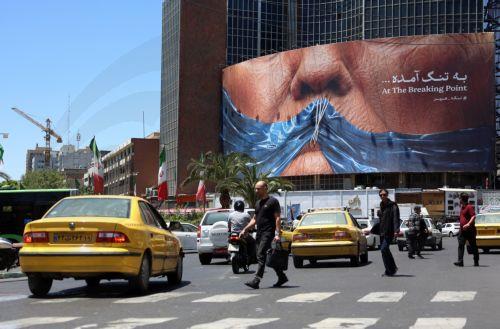 epa12992439 People drive in front of a large anti-US billboard featuring US President Donald Trump and the Strait of Hormuz at Valiasr Square in Tehran, Iran, 25 May 2026. The US and Iran voiced optimism regarding a potential peace agreement and the reopening of the Strait of Hormuz, though both sides emphasized that no such deal has been reached yet. ...