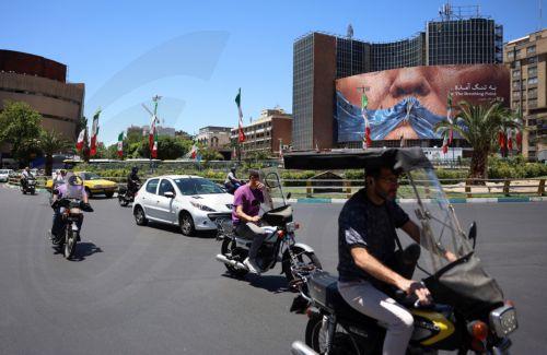 epa12992445 People drive in front of a large anti-US billboard featuring US President Donald Trump and the Strait of Hormuz at Valiasr Square in Tehran, Iran, 25 May 2026. The US and Iran voiced optimism regarding a potential peace agreement and the reopening of the Strait of Hormuz, though both sides emphasized that no such deal has been reached yet. ...