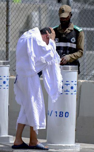 epa12992723 A Muslim pilgrim refresh himself at one of the water fountains on his way to the Mina tent camp on Yawm al-Tarwiyah (the Day of Watering) for the start of the Hajj 2026 pilgrimage in Mecca, Saudi Arabia, 25 May 2026. According to Saudi authorities, more than 1.5 million pilgrims from abroad had arrived in the country to perform Hajj in 2026. ...