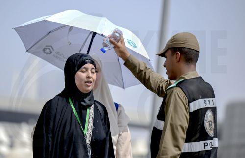 epa12992730 A Muslim pilgrim receives refreshment from a policeman on her way to the Mina tent camp on Yawm al-Tarwiyah (the Day of Watering) for the start of the Hajj 2026 pilgrimage in Mecca, Saudi Arabia, 25 May 2026. According to Saudi authorities, more than 1.5 million pilgrims from abroad had arrived in the country to perform Hajj in 2026. ...