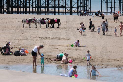 epa12997824 People spend time on the beach at the seaside resort of Blackpool, Britain, 27 May 2026. The UK is experiencing a record-breaking heatwave, with temperatures exceeding 35 degrees Celsius, marking the hottest May on record.  EPA/ADAM VAUGHAN