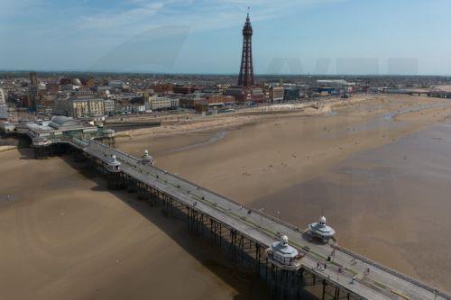 epa12997965 An aerial photograph taken with a drone shows people on North Pier boardwalk in Blackpool, Britain, 27 May 2026. The UK is experiencing a record-breaking heatwave, with temperatures exceeding 35 degrees Celsius, making May the hottest on record.  EPA/ADAM VAUGHAN