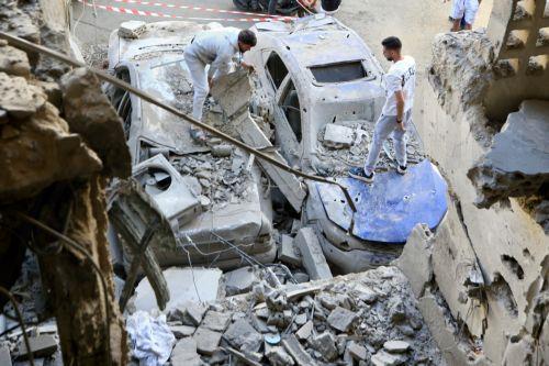 epa12999965 People inspect the site targeted by an Israeli airstrike in the southern coastal city of Sidon, Lebanon, 28 May 2026. At least four people were killed and several others injured in the attack. On 27 May, Israel had designated all regions south of the Zahrani River in Lebanon, roughly 40km from the border, including Tyre, as 'combat zones' and...