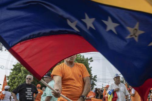epaselect epa13006059 A person waves a Venezuelan flag at a demonstration in Maracaibo, Venezuela, 30 May 2026. More than a thousand Venezuelans, along with several of the country’s leading opposition figures, gathered in Maracaibo, the capital of Zulia state to demand the holding of presidential elections and the release of all political prisoners. ...