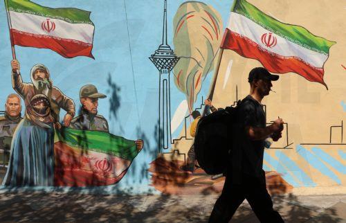epa13012530 An Iranian man walks next to an anti-US and Israeli mural in Tehran, Iran, 03 June 2026. Iran and the US traded strikes despite a ceasefire as the conflict involving Iran, the US, and Israel continues. According to US Central Command (CENTCOM), US forces intercepted multiple Iranian ballistic missiles and drones and conducted self-defense...