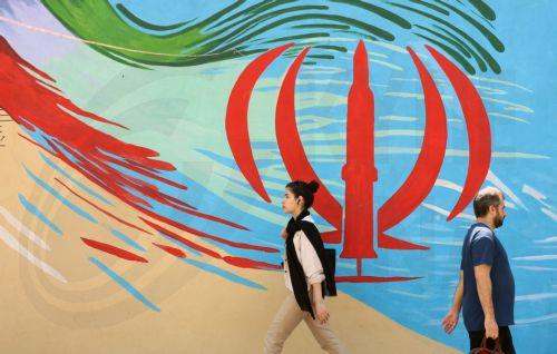epa13012535 Iranians walk next to an anti-US and Israeli mural in Tehran, Iran, 03 June 2026. Iran and the US traded strikes despite a ceasefire as the conflict involving Iran, the US, and Israel continues. According to US Central Command (CENTCOM), US forces intercepted multiple Iranian ballistic missiles and drones and conducted self-defense strikes on...