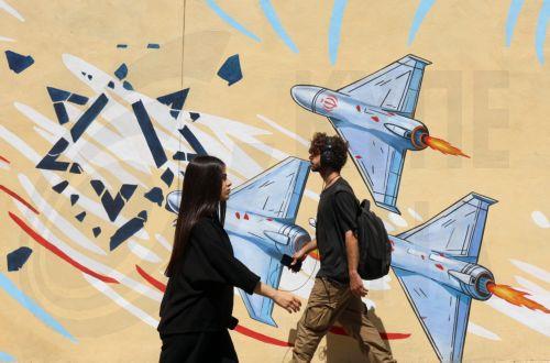 epa13012537 Iranians walk next to an anti-US and Israeli mural in Tehran, Iran, 03 June 2026. Iran and the US traded strikes despite a ceasefire as the conflict involving Iran, the US, and Israel continues. According to US Central Command (CENTCOM), US forces intercepted multiple Iranian ballistic missiles and drones and conducted self-defense strikes on...