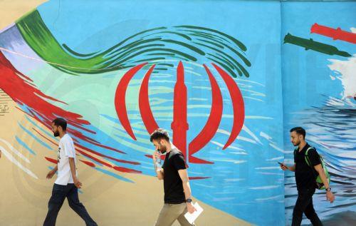 epa13012538 Iranians walk next to an anti-US and Israeli mural in Tehran, Iran, 03 June 2026. Iran and the US traded strikes despite a ceasefire as the conflict involving Iran, the US, and Israel continues. According to US Central Command (CENTCOM), US forces intercepted multiple Iranian ballistic missiles and drones and conducted self-defense strikes on...