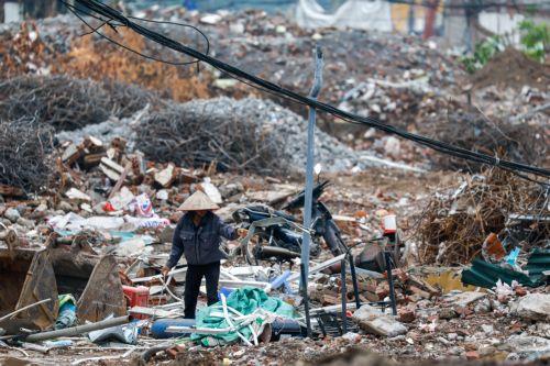 epa13017066 A woman collects garbage at a demolition site in Hanoi, Vietnam, 05 June 2026. World Environment Day is celebrated globally every year on 05 June and aims to bring awareness to environmental issues. The theme for 2026 is ‘Inspired by Nature. For Climate. For Our Future’.  EPA/LUONG THAI LINH