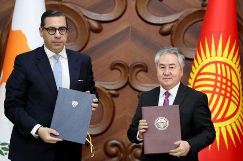 epa13024037 Cypriot Foreign Minister Constantinos Kombos (L) and Kyrgyz Foreign Minister Jeenbek Kulubayev (R) hold documents during a meeting in Bishkek, Kyrgyzstan, 08 June 2026. Kombos is on an official visit to Bishkek.  EPA/IGOR KOVALENKO