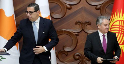 epa13024040 Cypriot Foreign Minister Constantinos Kombos (L) and Kyrgyz Foreign Minister Jeenbek Kulubayev (R) hold documents during a meeting in Bishkek, Kyrgyzstan, 08 June 2026. Kombos is on an official visit to Bishkek.  EPA/IGOR KOVALENKO