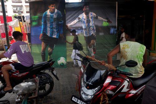 epa13032256 Indian soccer fans handle posters of Lionel Messi of Argentina in Kolkata, india, 12 June 2026. The FIFA World Cup 2026 runs from 11 June to 19 July 2026.  EPA/PIYAL ADHIKARY