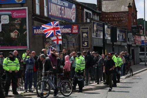 epa13034183 Anti-immigration protesters on County Road in Liverpool, Britain, 13 June 2026. Anti-immigration protesters calling for 'mass deportation' were met by counter-protesters on County Road, where a community library was burned down during rioting in the wake of the Southport murders in 2024.  EPA/STRINGER