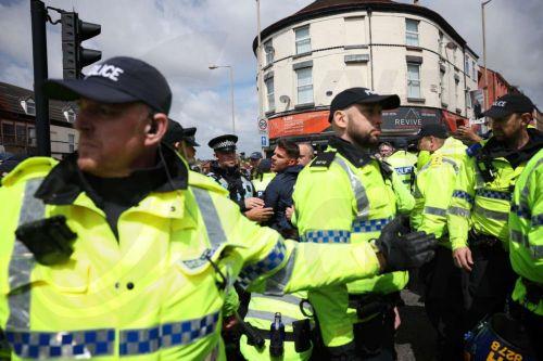 epa13034195 British far-right figure Ryan Ferguson (C) is arrested during a protest on County Road in Liverpool, Britain, 13 June 2026. Anti-immigration protesters calling for 'mass deportation' were met by counter-protesters on County Road, where a community library was burned down during rioting in the wake of the Southport murders in 2024.  EPA/STRINGER