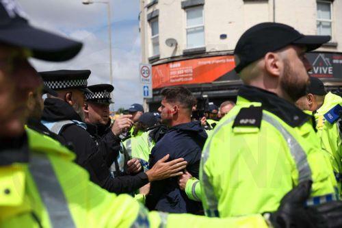 epa13034196 British far-right figure Ryan Ferguson (C) is arrested during a protest on County Road in Liverpool, Britain, 13 June 2026. Anti-immigration protesters calling for 'mass deportation' were met by counter-protesters on County Road, where a community library was burned down during rioting in the wake of the Southport murders in 2024.  EPA/STRINGER