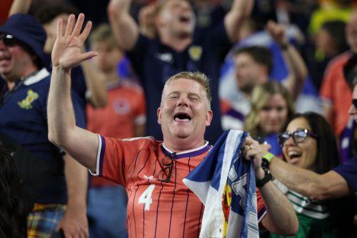 epa13035722 A supporter of Scotland celebrates winning the FIFA World Cup 2026 group stage match Haiti against Scotland, in Foxborough, Massachusetts, USA, 13 June 2026.  EPA/GREG M. COOPER
