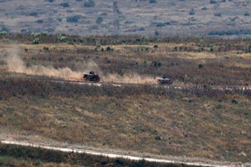 epa13044300 Israeli military vehicles move within southern Lebanon, as seen from the Israeli side of the border in the Upper Galilee, northern Israel, 17 June 2026. An Israeli army spokesperson reported that a soldier was severely injured, two soldiers were moderately injured, and two additional soldiers were lightly injured as a result of an explosive...