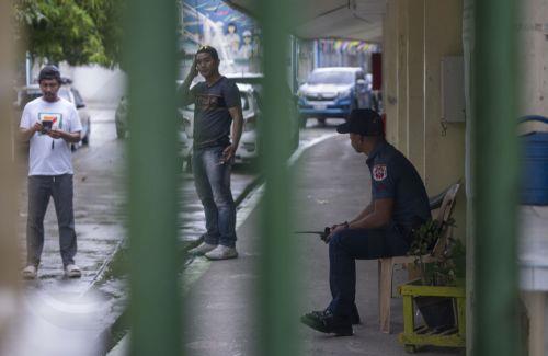 epa13056472 A police officer (R) keeps watch inside the premises of San Jose National High School in Tacloban City, Leyte Province, Philippines, 22 June 2026. According to the Tacloban City Police Office (TCPO), three students were killed and more than five others were injured and taken to medical facilities for treatment. TCPO said the two suspects have...