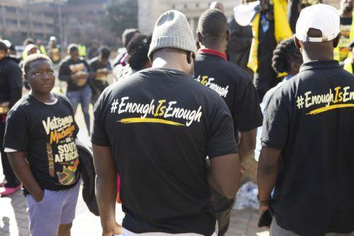 epa13066101 Members of the Tsonga tribe wearing 'Enough is Enough' t-shirts gather as they protest against the nation wide anti-immigrant movement that is planning a national shutdown on 30 June in Johannesburg, South Africa, 26 June 2026.  The march was organized in response to the killing of Nhlamulo Sambo in Mossel Bay (Western Cape), where he was...