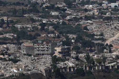 epa13070678 An Israeli flag waves atop a destroyed house in the southern Lebanese village of Meiss al-Jabal, as seen from the Israeli side of the border in the Upper Galilee, northern Israel, 28 June 2026, amid an Israel-Lebanon ceasefire.  EPA/ATEF SAFADI
