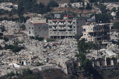 epa13070679 An Israeli flag waves atop a destroyed house in the southern Lebanese village of Meiss al-Jabal, as seen from the Israeli side of the border in the Upper Galilee, northern Israel, 28 June 2026, amid an Israel-Lebanon ceasefire.  EPA/ATEF SAFADI