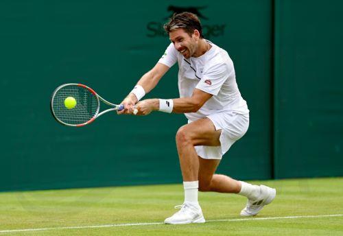 epa13072334 Cameron Norrie of Great Britain plays a backhand in his Men's Singles first round match against Michael Zheng of the USA at the Wimbledon Championships in London, Britain, 29 June 2026.  EPA/NEIL HALL