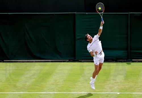 epa13072335 Cameron Norrie of Great Britain serves in his Men's Singles first round match against Michael Zheng of the USA at the Wimbledon Championships in London, Britain, 29 June 2026.  EPA/NEIL HALL