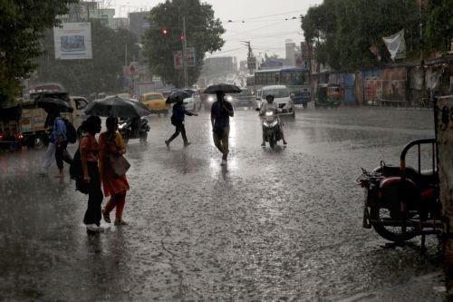 epa13072413 People make their way through a water logged street during heavy rain in Kolkata, India 29 June 2026. The India Meteorological Department (IMD) issued a red alert for thunderstorms with lightning and heavy rainfall, disrupting daily life across parts of West Bengal for the past several days.  EPA/PIYAL ADHIKARY