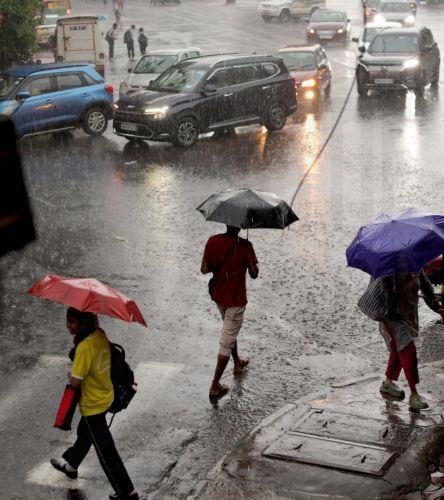 epa13072419 People make their way through a water logged street during heavy rain in Kolkata, India 29 June 2026. The India Meteorological Department (IMD) issued a red alert for thunderstorms with lightning and heavy rainfall, disrupting daily life across parts of West Bengal for the past several days.  EPA/PIYAL ADHIKARY