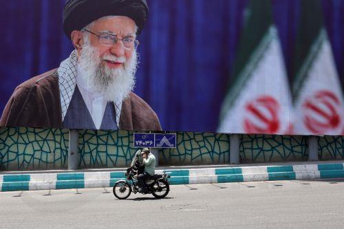 epa13077288 An Iranian man rides a motorbike past a large-scale poster of late Iranian Supreme Leader Ayatollah Ali Khamenei displayed along a highway, in Tehran, Iran, 01 July 2026. Iran is set to hold a multi-day state funeral from 04 to 09 July 2026 for late Iranian Supreme Leader Ayatollah Ali Khamenei, who was assassinated on 28 February.  EPA/ABEDIN...