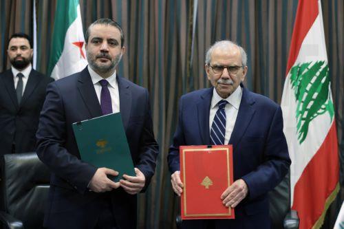 epa13079823 Lebanese Prime Minister Nawaf Salam (R) and Syrian Foreign Minister Asaad Al Shaibani (L) hold documents following the signing of an agreement on the formation of a joint Syrian‑Lebanese committee at the Government Palace, Lebanon, 02 July 2026. Shaibani is on an official visit to Beirut to meet Lebanon's leaders.  EPA/WAEL HAMZEH
