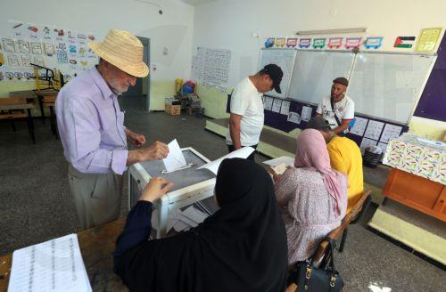 epa13079880 An Algerian man casts her ballot at a polling station during parliamentary elections in Algiers, Algeria, 02 July 2026. The electorate, including diaspora voters, comprises 24,727,041 registered voters. The elections will elect the 407 members of the tenth legislature of the National People’s Assembly (APN), who will serve five-year terms. ...