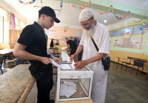 epa13079884 An Algerian man casts her ballot at a polling station during parliamentary elections in Algiers, Algeria, 02 July 2026. The electorate, including diaspora voters, comprises 24,727,041 registered voters. The elections will elect the 407 members of the tenth legislature of the National People’s Assembly (APN), who will serve five-year terms. ...