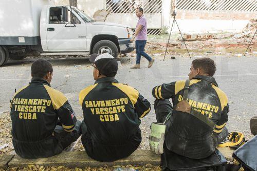 epa13081747 Members of the Cuban Search and Rescue team rest during a rescue operation to save Fabio, a nine-year-old boy who has been trapped under the rubble for eight days, in a collapsed building in Caraballeda, Venezuela, 02 July 2026. The 7.2- and 7.5-magnitude earthquakes that struck Venezuela on 24 June have killed more than 2,290 people, according...