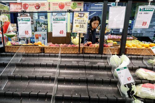 epa13102351 A resident purchases fruit next to an empty vegetable shelf in preparation as Typhoon Bavi approaches Hualien city, Taiwan, 10 July 2026. The Central Weather Administration expects Typhoon Bavi to impact Taiwan most severely from 10 July night through 11 July. Currently located 590 km east of Eluanbi and packing maximum sustained winds of 155...