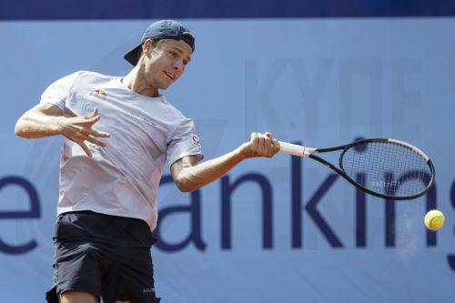 epa13108147 Joel Schwaerzler of Austria in action against Lorenzo Sonego of Italy during their men's single match at the Swiss Open tennis tournament in Gstaad, Switzerland, 13 July 2026.  EPA/PETER SCHNEIDER