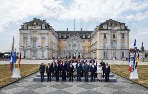 epa13116893 German Chancellor Friedrich Merz (C-R) and French President Emmanuel Macron (C-L) pose with ministers from both countries for a group picture during the 26th Franco-German Ministerial Council at Augustusburg Palace in Bruehl, Germany, 17 July 2026. France and Germany are expected to announce the first ever participation of German soldiers in...