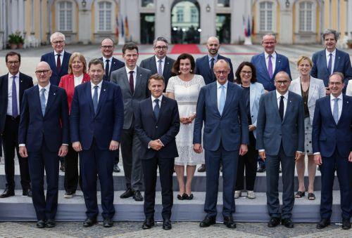 epa13116895 German Chancellor Friedrich Merz (C-R) and French President Emmanuel Macron (C-L) pose with ministers from both countries for a group picture during the 26th Franco-German Ministerial Council at Augustusburg Palace in Bruehl, Germany, 17 July 2026. France and Germany are expected to announce the first ever participation of German soldiers in...