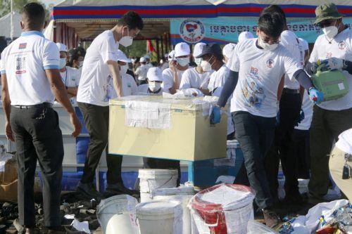 epa13124117 Cambodian officials prepare to burn seized illegal drugs during a drug destruction event in Kandal province, Cambodia, 21 July 2026. The Cambodian National Authority for Combating Drugs destroyed nearly five tons of illegal drug substance ingredients in an effort to fight against drug production, distribution and drug trafficking.  EPA/KITH SEREY