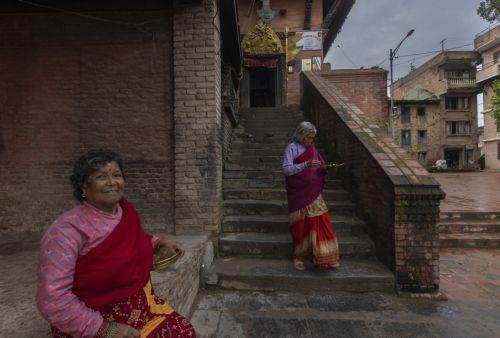 epa13124225 Elderly women visit the Bungamati Temple in Bungamati on the outskirts of Kathmandu, Nepal, 21 July 2026. Nepal's Meteorological Forecasting Division has announced that the monsoon season has officially begun across the country.  EPA/NARENDRA SHRESTHA