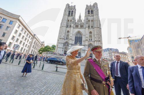 epa13124367 Queen Mathilde (L) and King Philippe of Belgium greet people outside the St. Michael & St. Gudula Cathedral after the Te Deum mass during Belgium's National Day celebrations in Brussels, Belgium, 21 July 2026.  EPA/OLIVIER MATTHYS