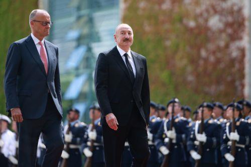 epa13124407 German Chancellor Friedrich Merz (L) welcomes Azerbaijani President Ilham Aliyev with military honors at the Chancellery in Berlin, Germany, 21 July 2026. Merz and Aliyev met for bilateral talks.  EPA/CLEMENS BILAN