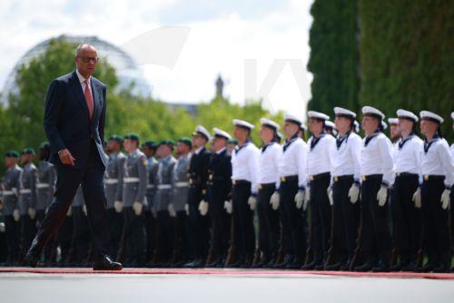 epa13124408 German Chancellor Friedrich Merz walks prior to the arrival of Azerbaijani President Ilham Aliyev (not pictured) and a reception with military honors in front of soldiers at the Chancellery in Berlin, Germany, 21 July 2026. Merz and Aliyev met for bilateral talks.  EPA/CLEMENS BILAN