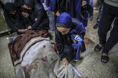 epa13124411 A Palestinian relative of the Al-Masri family mourns near their bodies in the morgue of Al-Shifa Hospital, in Gaza City, Gaza Strip, 21 July 2026. Firas Al-Masri, his wife, Salsabil, and their four children were killed in Gaza City, when the Israeli army targeted their home with a drone early 21 July, according to the Gaza Ministry of Health. ...