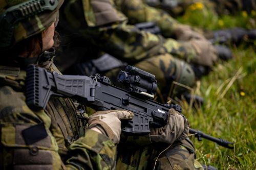 epa13130738 A participant holds an assault rifle CZ BREN 2 as high school students take a rest as they train in basic military skills during the final field exercise of a month-long voluntary military training course organized by the Czech Army at the Hradiste Military Area, near Bochov, Czech Republic, 24 July 2026. The Hradiste Military Area is one of ten...