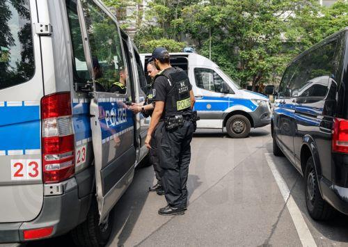 epa13133458 Police officers stand at a building after an apartment was searched last night near the scene where a vehicle plowed into a crowd on the sidelines of the Christopher Street Day (CSD) parade in Berlin, Germany, 26 July 2026.  One person died and 16 others were injured on the sidelines of the Christopher Street Day event in Berlin after a vehicle...