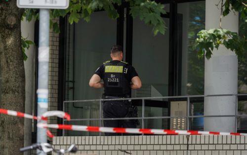 epa13133459 A police officer stands at a building after an apartment was searched last night near the scene where a vehicle plowed into a crowd on the sidelines of the Christopher Street Day (CSD) parade in Berlin, Germany, 26 July 2026.  One person died and 16 others were injured on the sidelines of the Christopher Street Day event in Berlin after a...