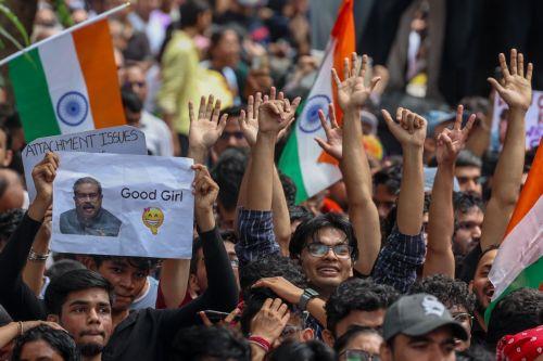 epa13133541 Supporters of the youth-led satirical political movement Cockroach Janta Party (CJP) celebrate the resignation of Union Education Minister Dharmendra Pradhan, in Mumbai, India, 26 July 2026. Pradhan tendered his resignation on 25 July following nationwide student protests over examination paper leaks.  EPA/DIVYAKANT SOLANKI